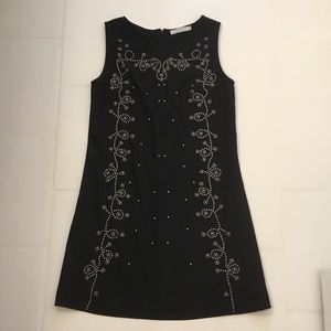 Sleeveless black dress with bead appliqués